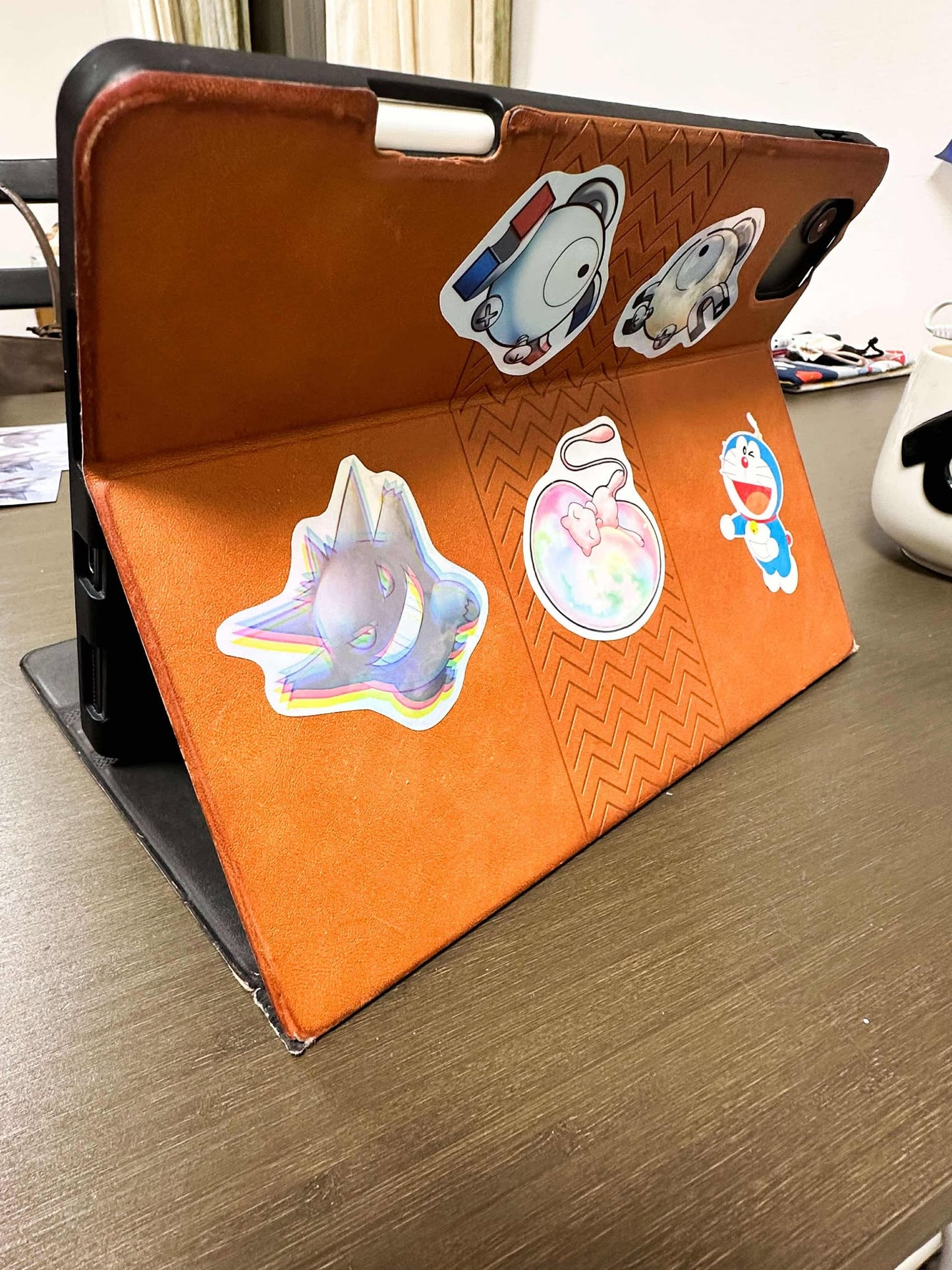 showing the stickers on different things like an ipad case for the color shift pokemon gengar sticker