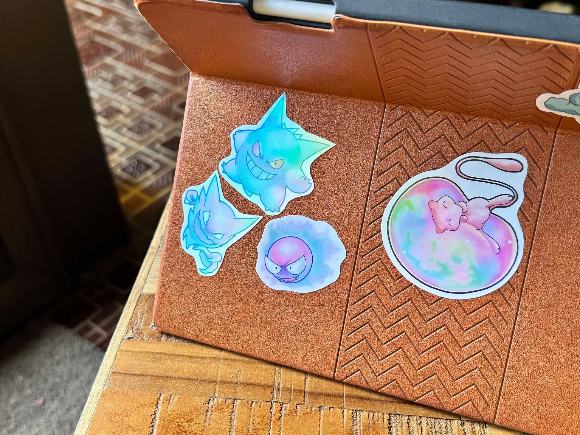 showing the stickers on a case with a different angle for the pastel pokemon gengar, haunter and gastly stickers